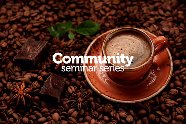 cup of coffee surrounded by chocolate