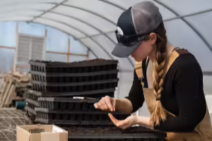 Women testing soil in a green house