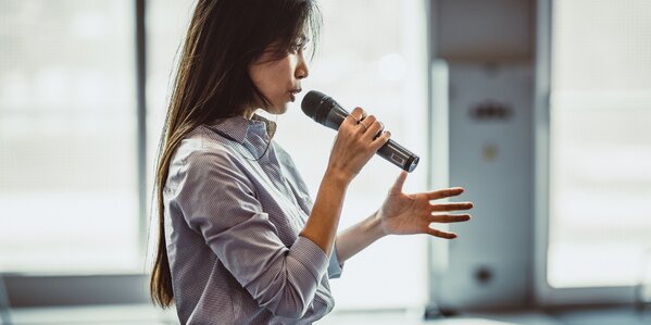woman speaking into microphone