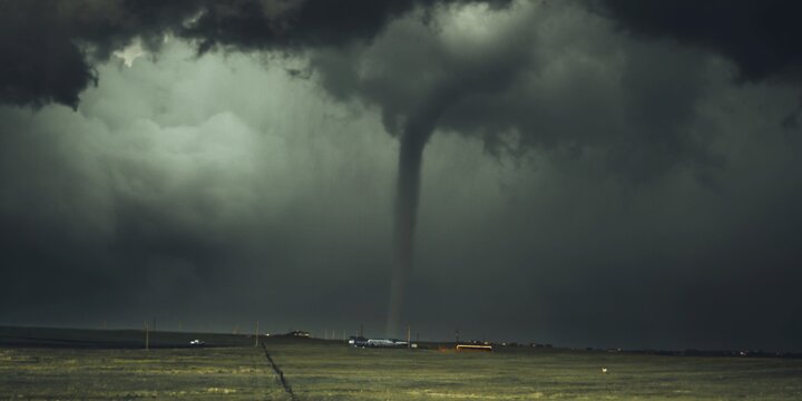 Tornado coming through a farm field