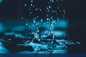 water drop splashing from a puddle on the ground