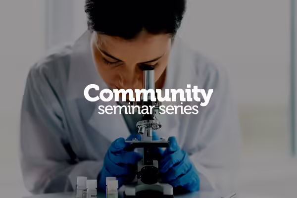 woman looking through microscope