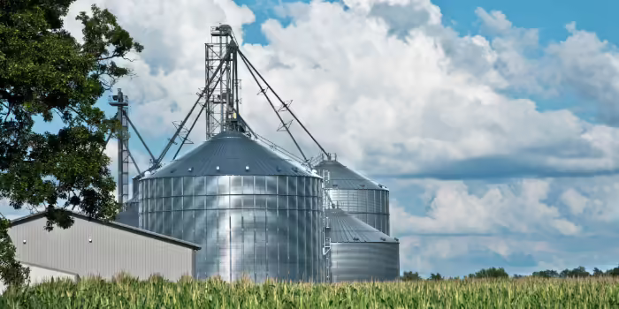 silver silos in a field
