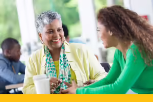 two women at a breakroom table