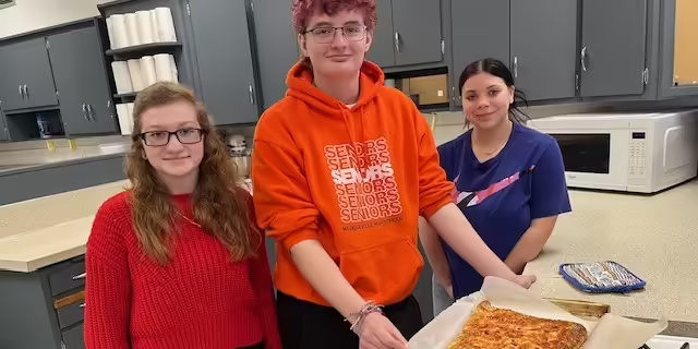 Teens cooking in a school kitchen