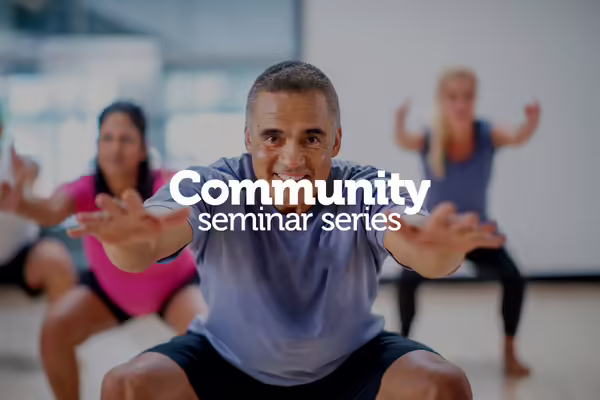 man doing squats in exercise class