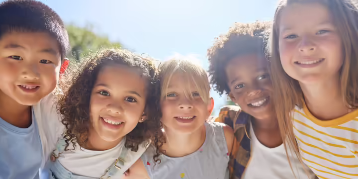 kids smiling with arms around each other