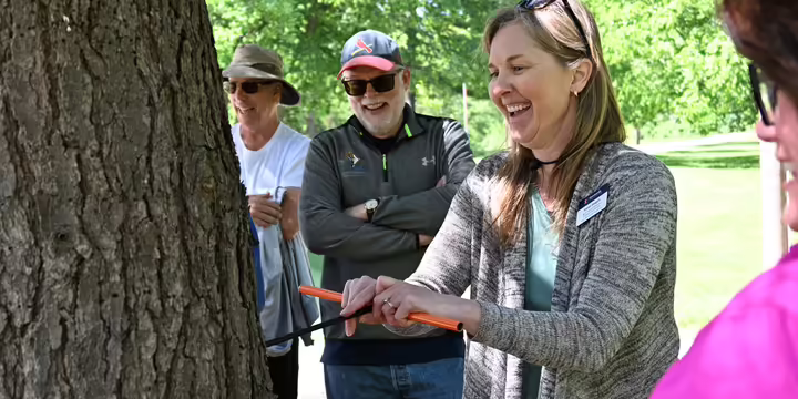 Karen Weigelt taking core sample from tree