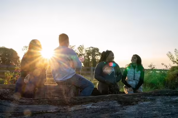 four friends sharing stories during sunset