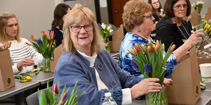 a lady doing a flower arrangement