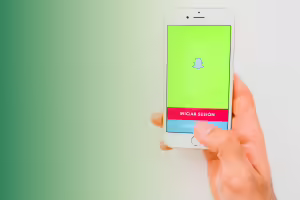 cell phone in a persons hand with snapchat log in on the screeen