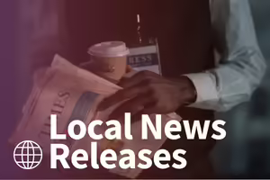 black man holding a newspaper