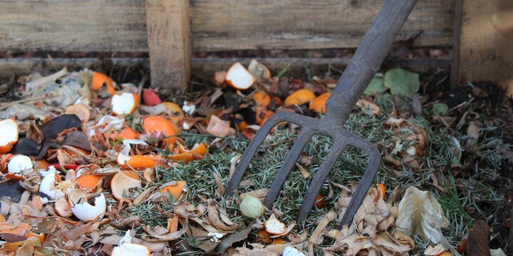 a pitch fork in a compost pile