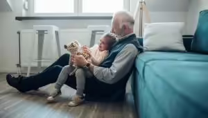Grandfather reading to child