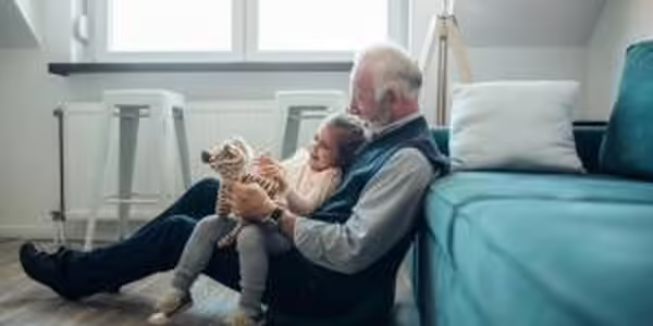 Grandfather reading to grandchild