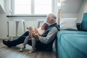 Grandfather reading to grandchild