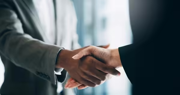 photo showing two people shaking hands