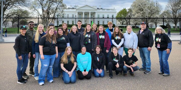 Picture of teens posing on street in front of the White House