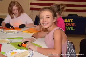 girl cutting a carrot