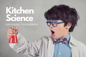 little boy with blue glasses holding beaker