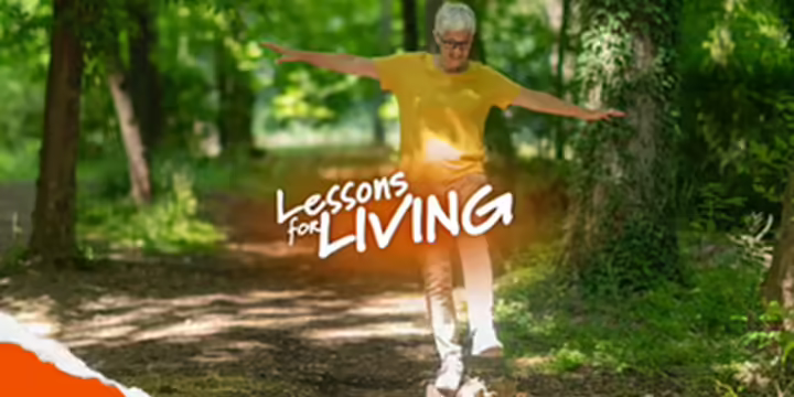 Person balancing on a log in the woods