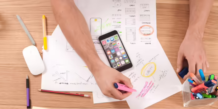 A person trying to track their work on a piece of paper.