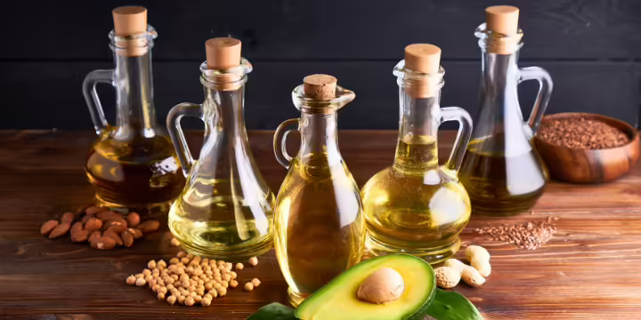 Bottles of oil with seeds and avocado