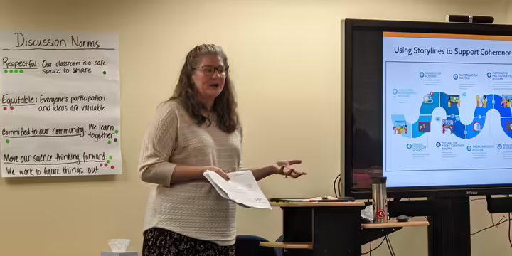 A presenter explains a science storyline curricular model