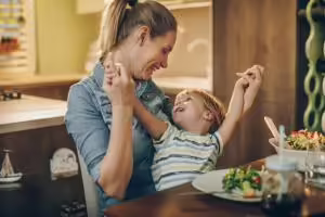 Mother and son at dinner table