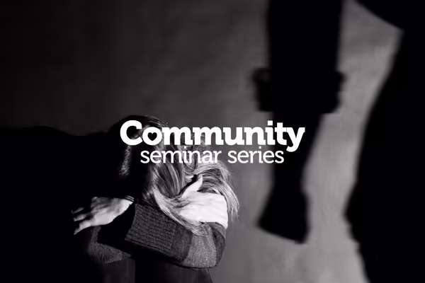 woman crouching on floor against a man with clinched fist