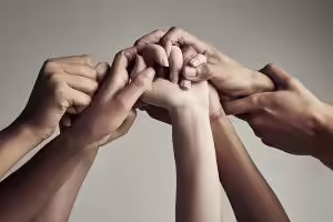 Intertwined hands of different skin tones