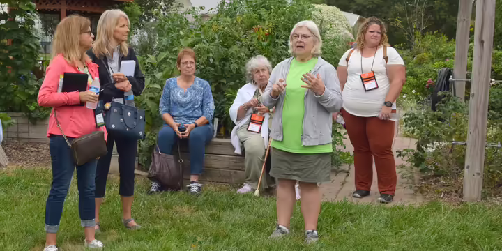 Master Garden speaking to a group in the garden