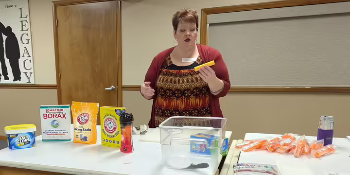 Woman speaking in front of demonstration table