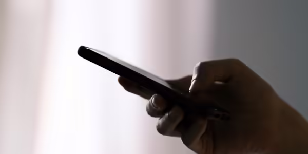 Someone texting on a smart phone in a dark room