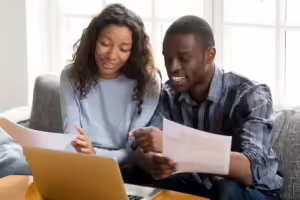 man and woman looking at finances