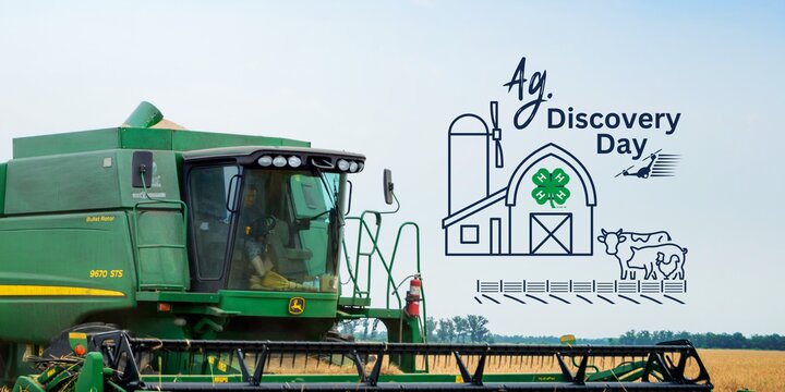 a green combine in a wheat field