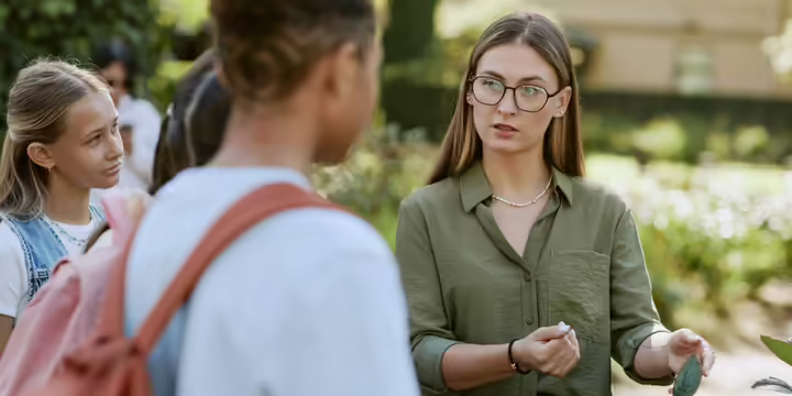 Woman teaching youth about gardening 