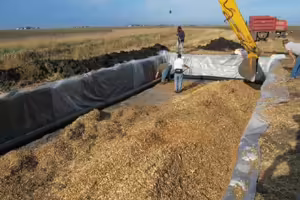 backhoe digging a controlled waterway