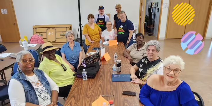 People sitting at a table looking at the camera