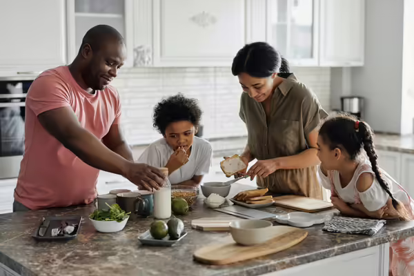 family learning how to create a healthy meal