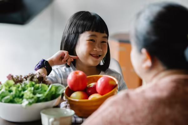 Mother and daughter sharing a healthy snack