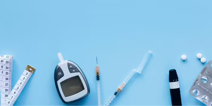 Medical supplies related to diabetes management on a blue background, including a glucometer, two syringes, a measuring tape, tablets, a blood sugar testing device, and a blister pack of pills