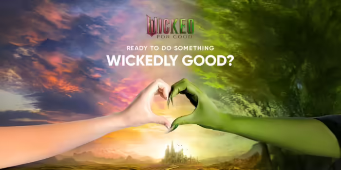 Glinda and Elphaba from Wicked movie making heart hands 