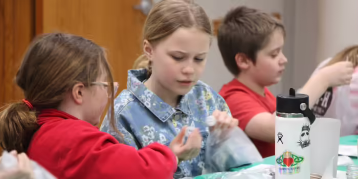 Warren County 4-H members concentrating while practicing their cookie decorating skills