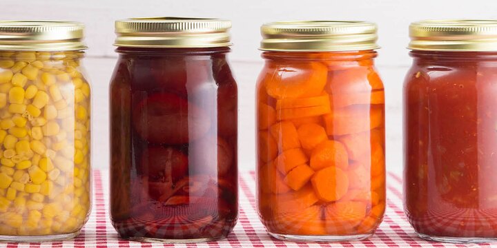 jars of canned corn, beets, carrots, and tomatoes
