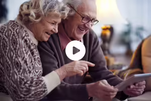 two people watching ipad