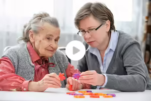 woman helping elder woman with dementia