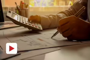 person with calculator and pencil