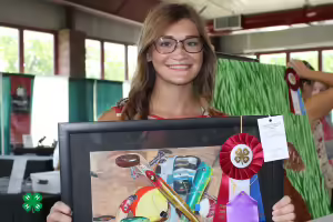 girl holding painting she made