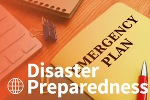 emergency plan book sitting on a table with a laptop and notebook